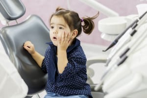 Little Girl with Pigtails Feels a Little Anxious at the Dentist